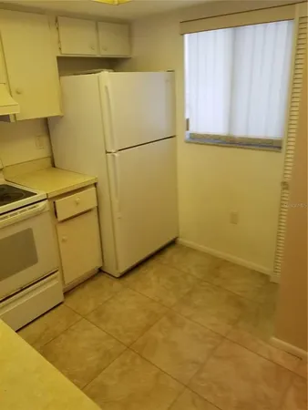 a view of a refrigerator in a room