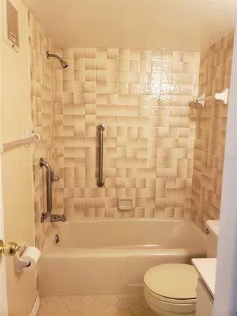 a bathroom with a toilet and shower