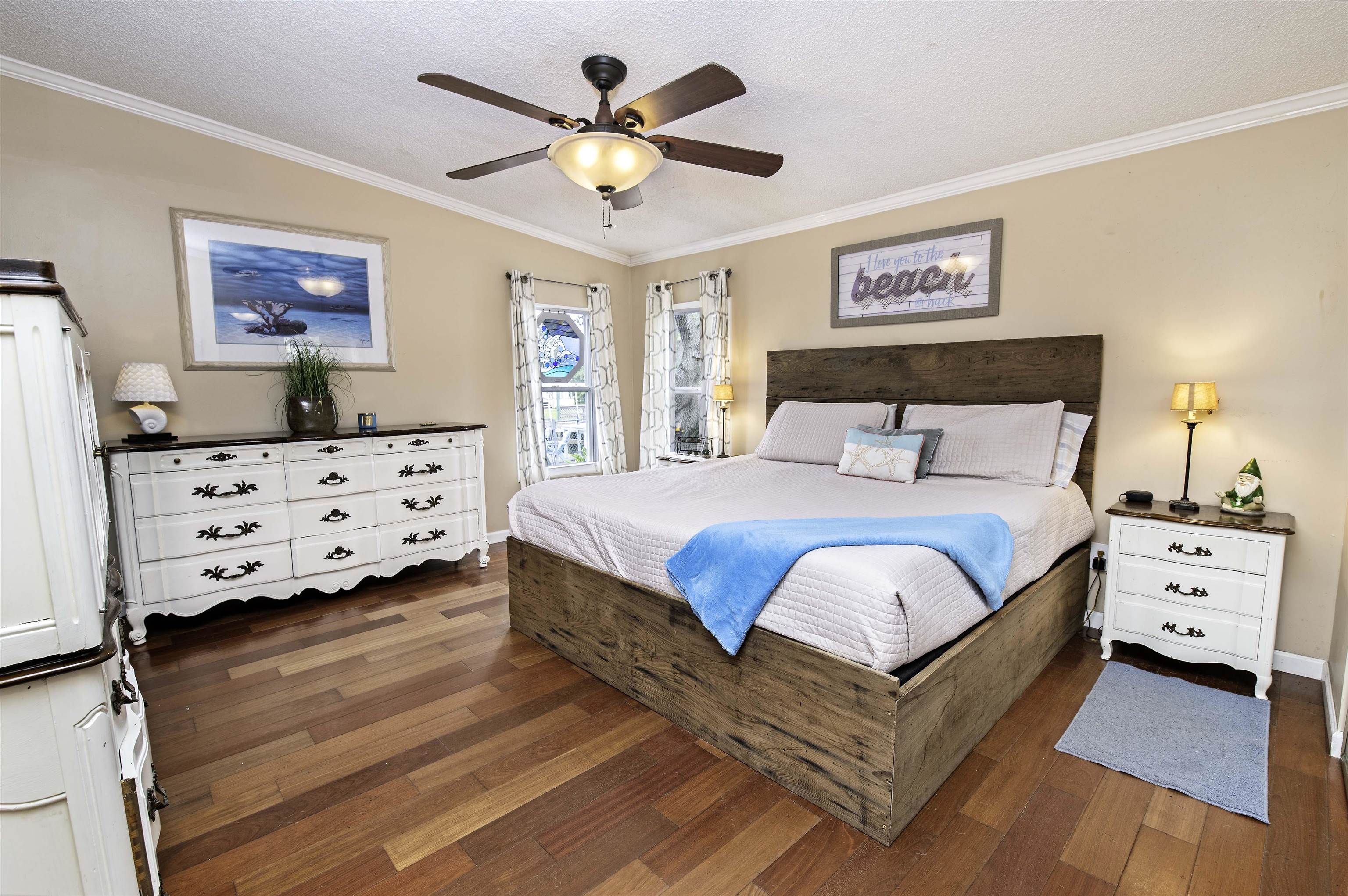 266 Pizarro Road St. Augustine, FL 32080 - Photo 14 of 26 a bedroom with a bed and a chandelier