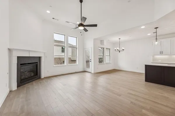 a view of an empty room with a fireplace and a window