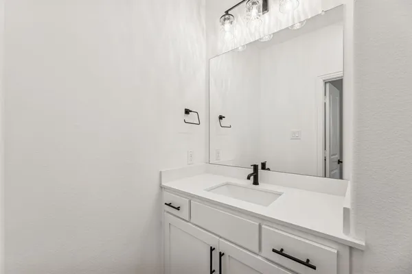 a bathroom with a sink and mirror