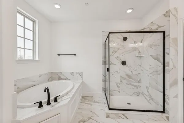 a bathroom with a tub and a shower