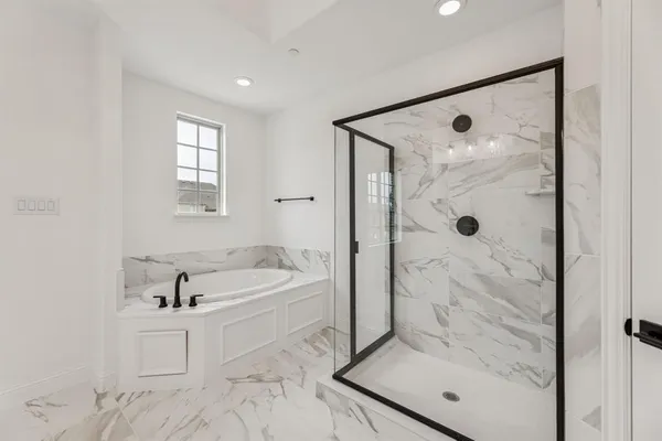 a bathroom with a tub shower and a sink