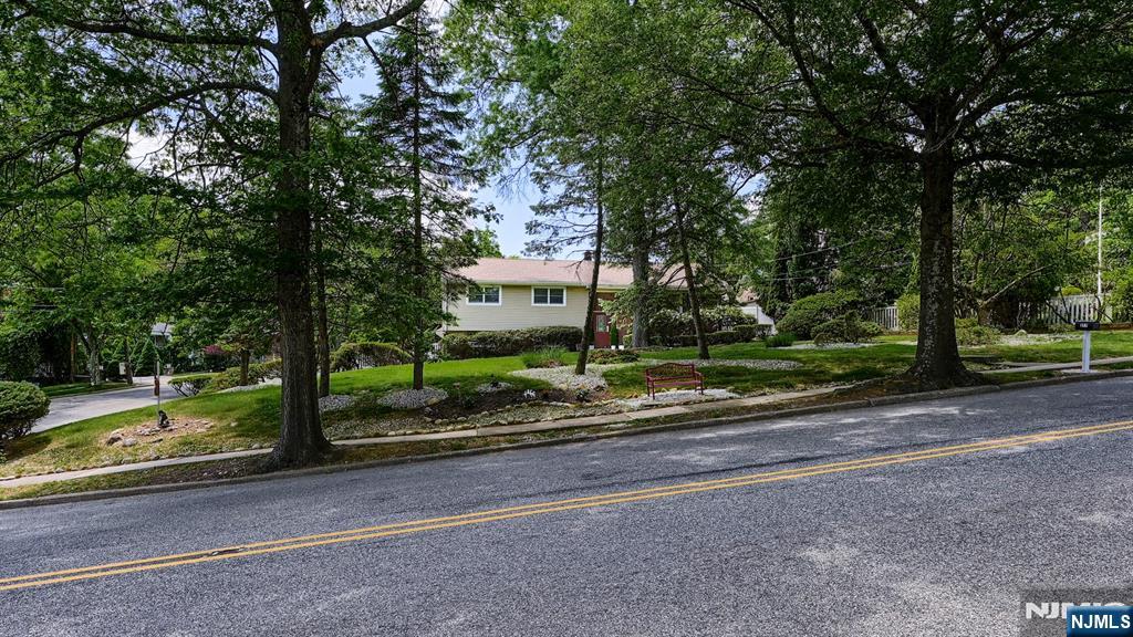 277 French Hill Road Wayne, NJ 07470 - Photo 3 of 28 a sign board with street parked next to road and trees
