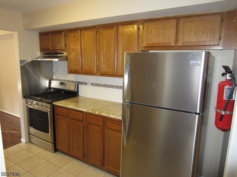 164 Vista Drive Cedar Knolls, NJ 07927 - Photo 2 of 19 a metallic refrigerator freezer sitting in a kitchen