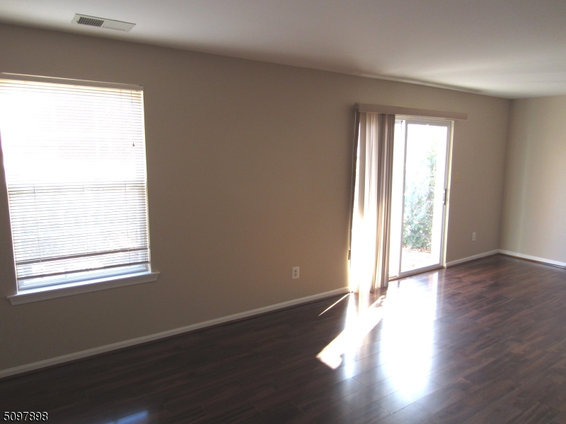 164 Vista Drive Cedar Knolls, NJ 07927 - Photo 11 of 19 an empty room with wooden floor and windows