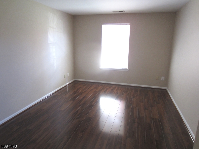 164 Vista Drive Cedar Knolls, NJ 07927 - Photo 13 of 19 an empty room with wooden floor and windows