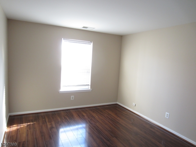 164 Vista Drive Cedar Knolls, NJ 07927 - Photo 17 of 19 an empty room with wooden floor and windows