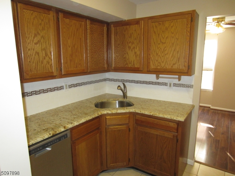 164 Vista Drive Cedar Knolls, NJ 07927 - Photo 3 of 19 a bathroom with a granite countertop sink and a mirror