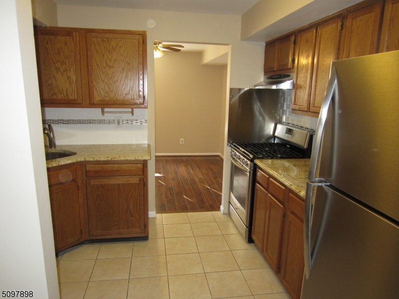164 Vista Drive Cedar Knolls, NJ 07927 - Photo 4 of 19 a kitchen with a refrigerator stove and cabinets