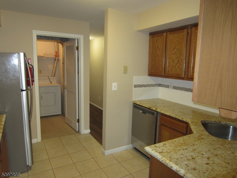 164 Vista Drive Cedar Knolls, NJ 07927 - Photo 5 of 19 a kitchen with stainless steel appliances granite countertop a sink and a refrigerator