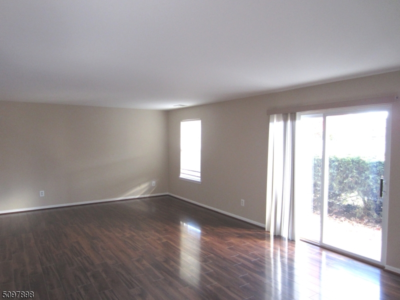 164 Vista Drive Cedar Knolls, NJ 07927 - Photo 10 of 19 an empty room with wooden floor and windows