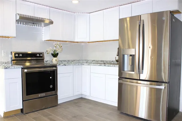 an empty room with wooden floor and window