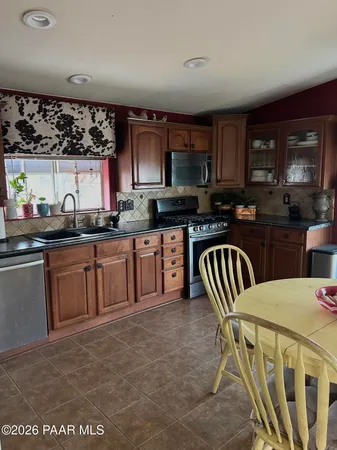 a kitchen with granite countertop a sink and cabinets