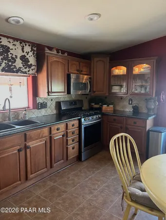a kitchen with stainless steel appliances a stove a sink and a microwave