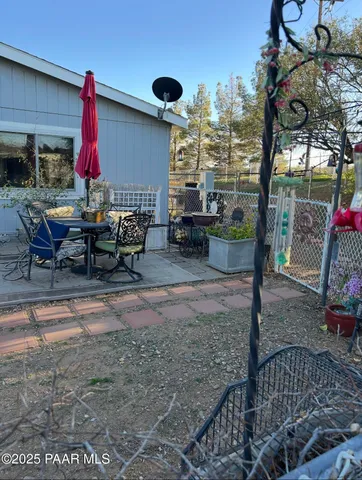 a view of a patio with a table and chairs