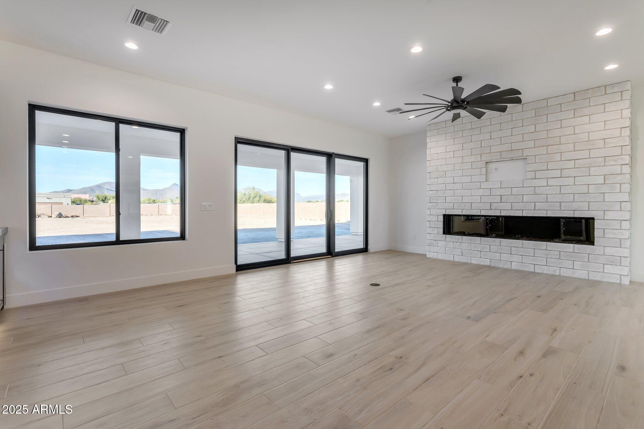 1602 East Cloud Road Phoenix, AZ 85086 - Photo 16 of 45 a view of an empty room with a window and wooden floor