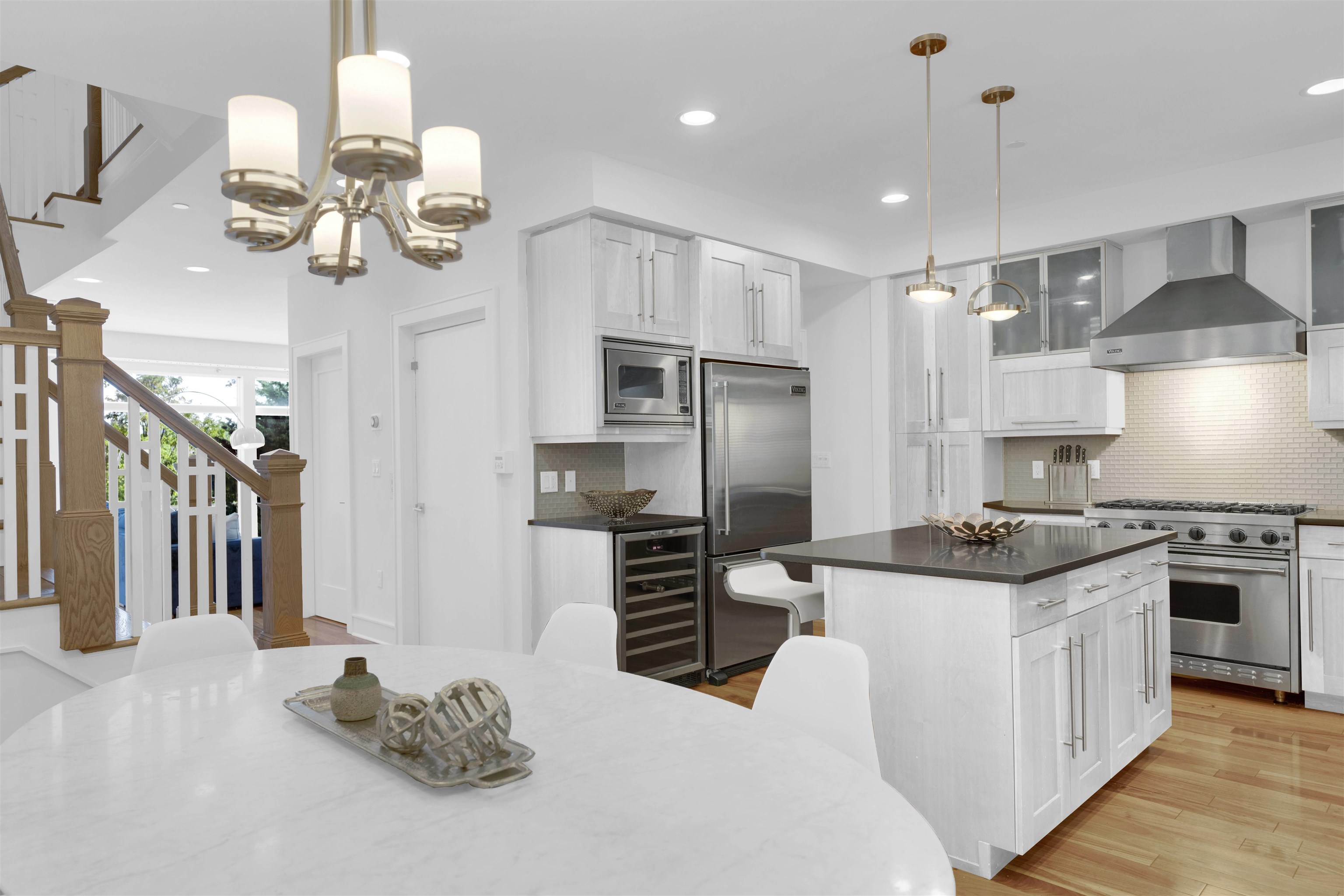 a kitchen with stainless steel appliances kitchen island granite countertop a stove and a refrigerator
