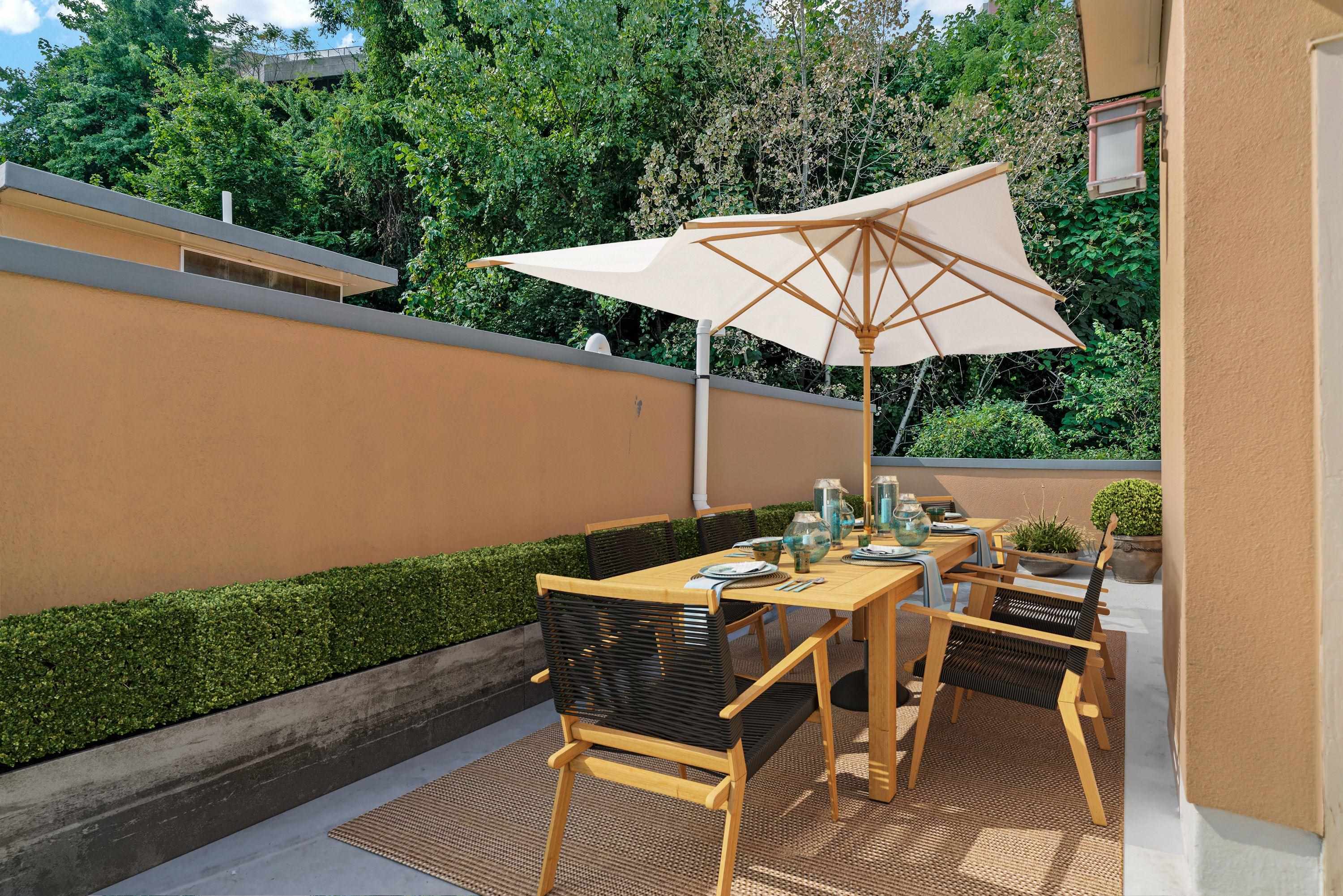 8713-6 Churchill Road, Unit 6 North Bergen, NJ 07047 - Photo 19 of 23 a patio with a table and chairs under an umbrella