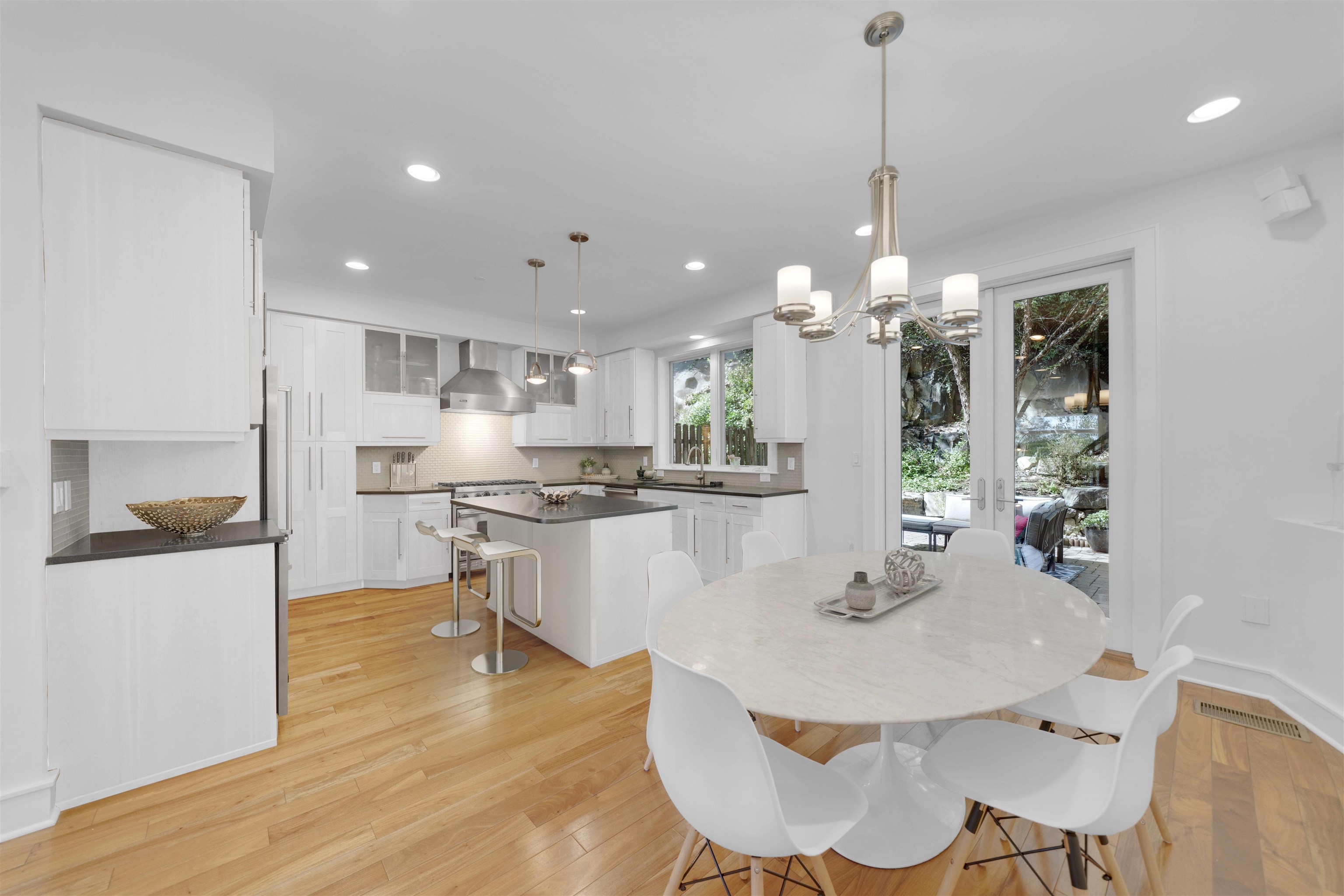 8713-6 Churchill Road, Unit 6 North Bergen, NJ 07047 - Photo 2 of 23 a kitchen with kitchen island a dining table and chairs