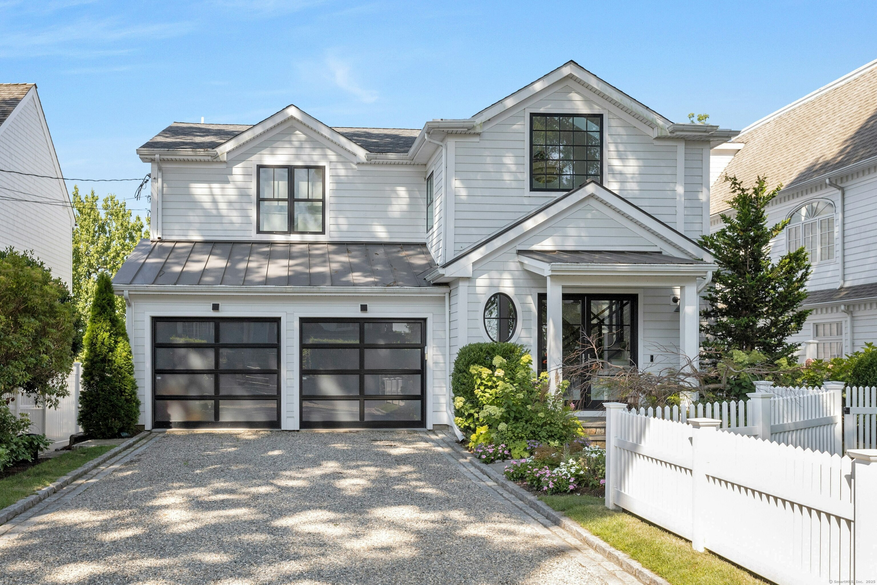 47 Pine Point Road Norwalk, CT 06853 - Photo 1 of 1 a front view of a house with a yard and potted plants