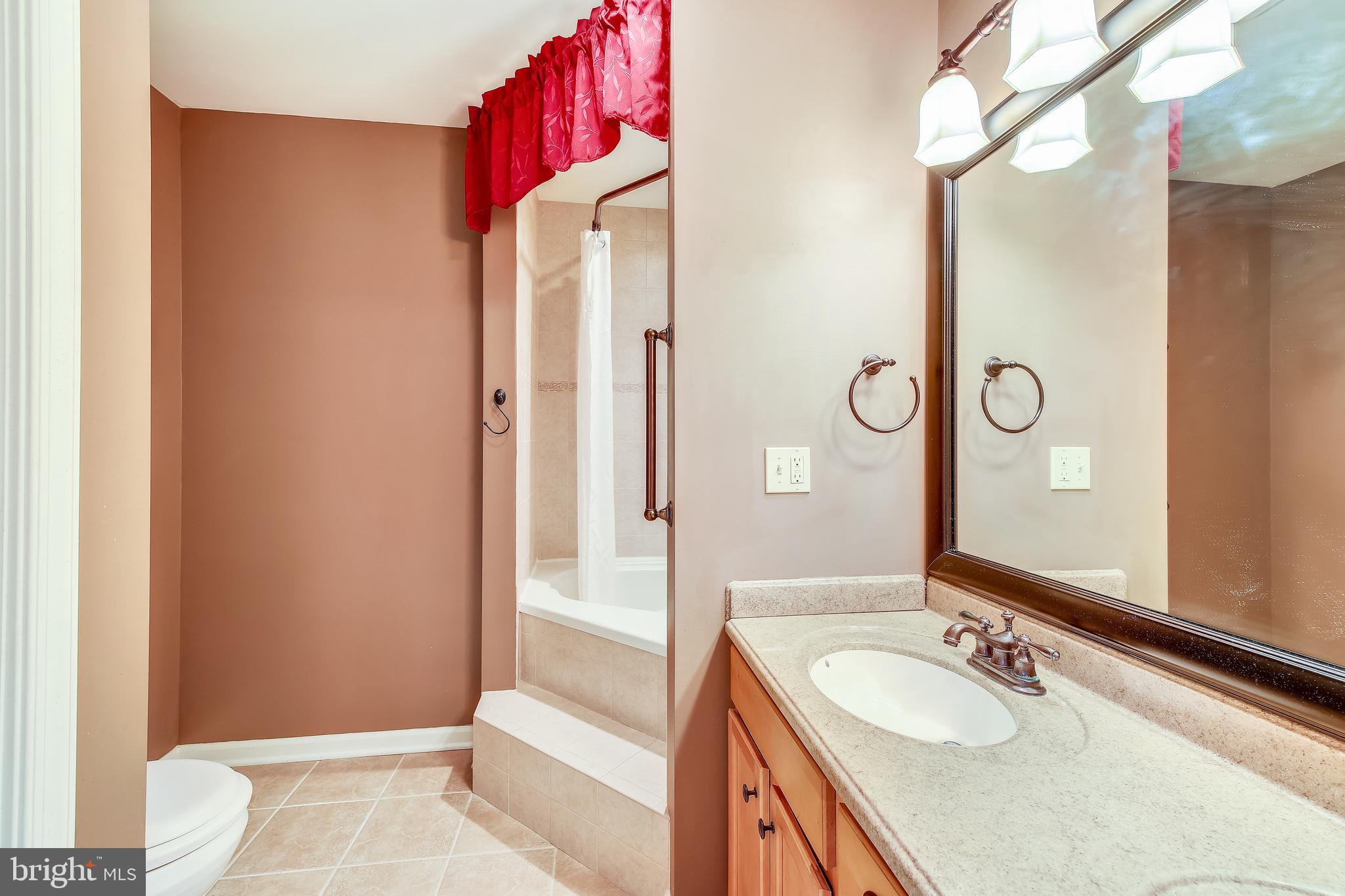 9248 Bethel Road Willards, MD 21874 - Photo 19 of 47 a bathroom with a granite countertop sink and a mirror
