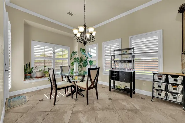a view of a dining room with furniture and a chandelier