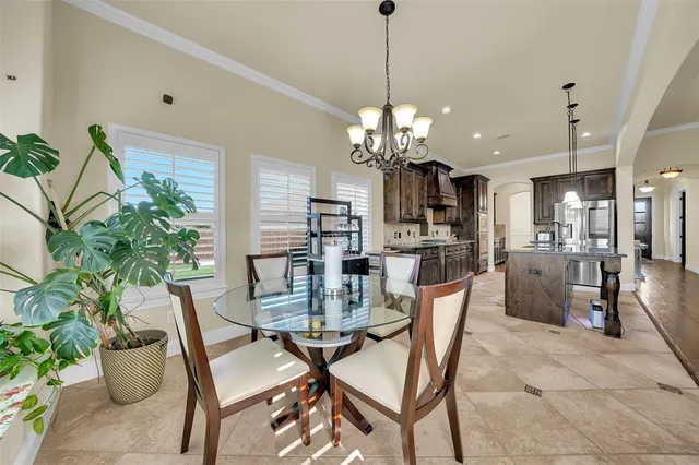 a dining room with furniture a chandelier and wooden floor