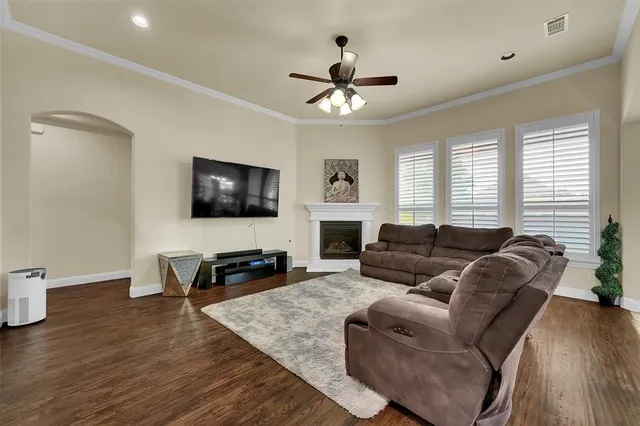 a living room with furniture a flat screen tv and a fireplace
