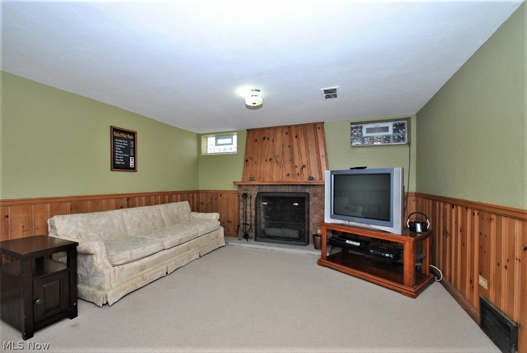 2328 Traymore Road Cleveland, OH 44118 - Photo 16 of 25 Carpeted LL rec room features fireplace and paneling