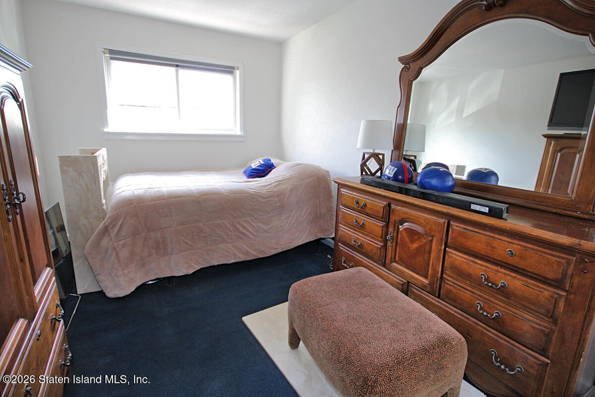 951 West Fingerboard Road Staten Island, NY 10304 - Photo 16 of 29 a bedroom with a bed and a dresser