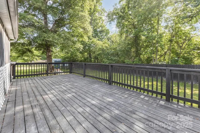 a view of a house with a yard and deck