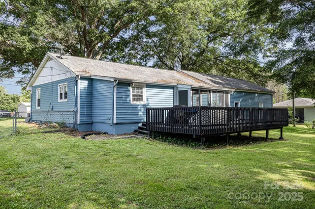 a view of a house with backyard and deck