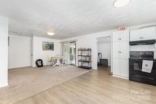 a view of a livingroom with furniture and an empty room