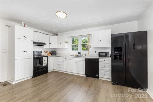 a kitchen with a refrigerator stove and wooden cabinets