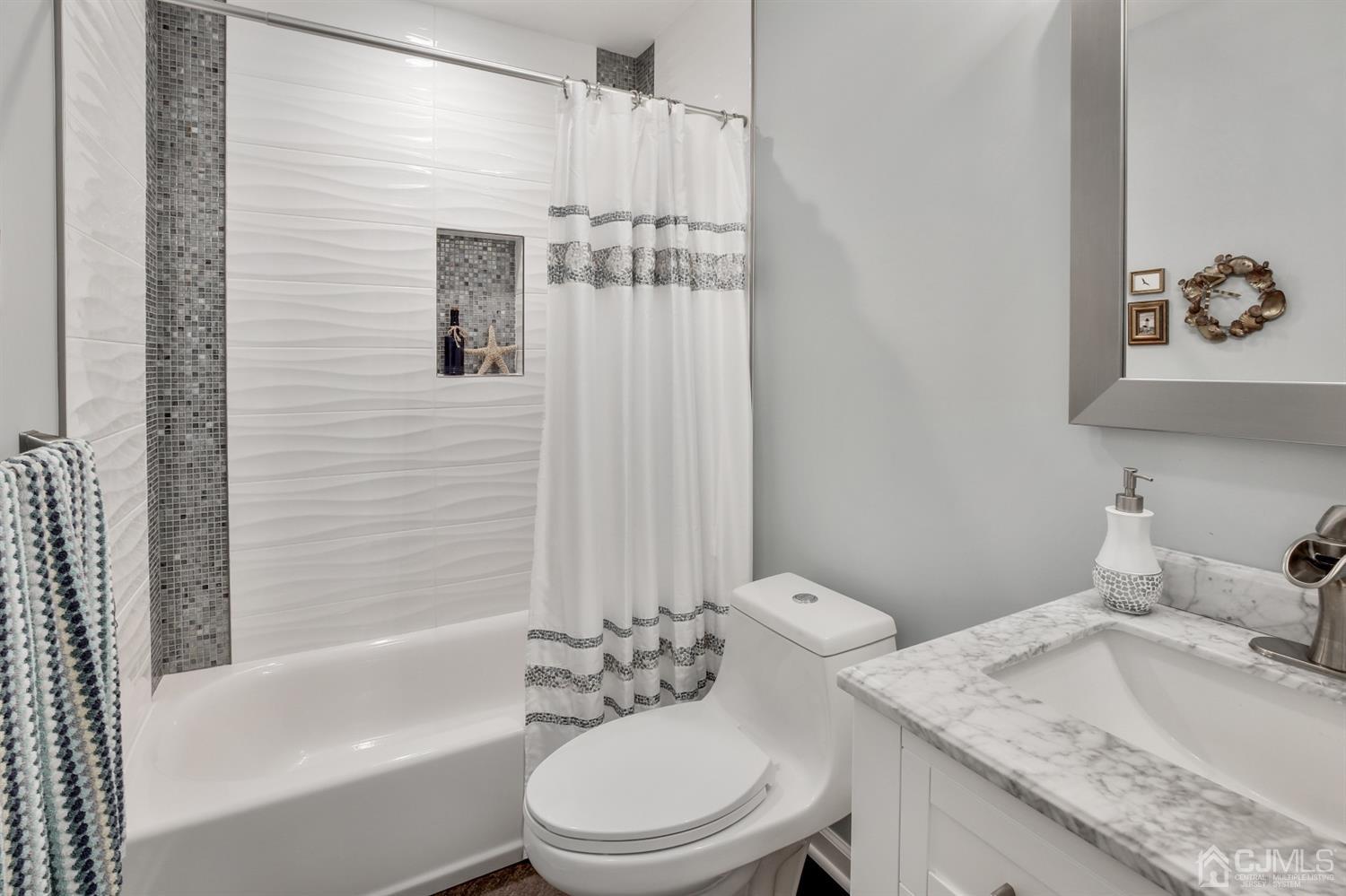 971 Carteret Road Bridgewater, NJ 08807 - Photo 14 of 27 a bathroom with a granite countertop toilet a sink and a bathtub
