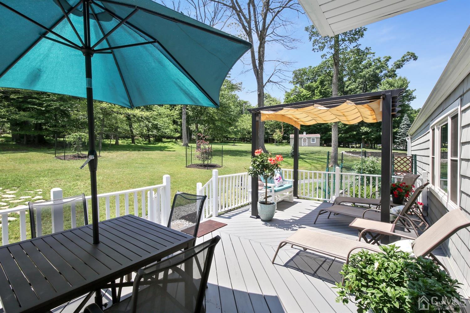 971 Carteret Road Bridgewater, NJ 08807 - Photo 22 of 27 a view of a patio with a table chairs and a umbrella