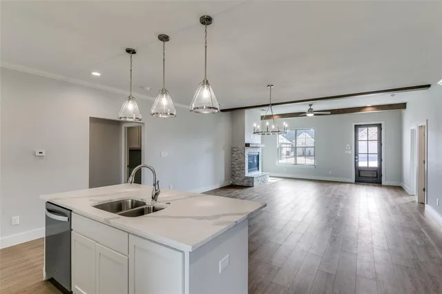 a view of a kitchen with a sink and chandelier