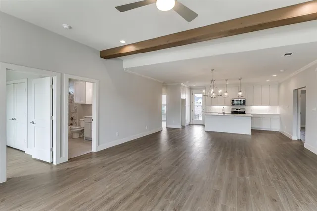 a view of kitchen and hall with wooden floor