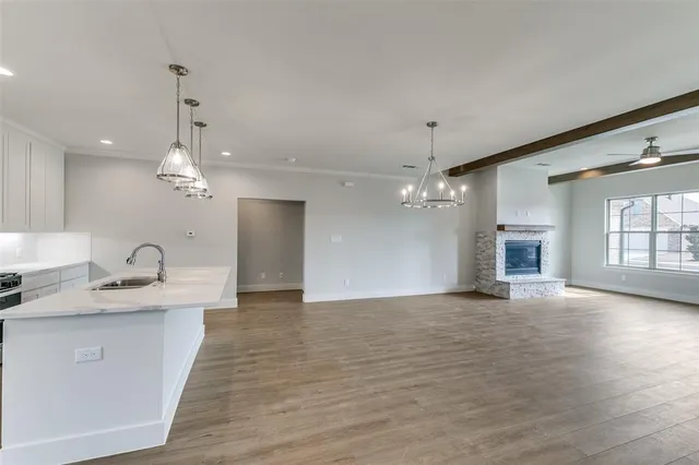 a view of a kitchen with a sink and a chandelier