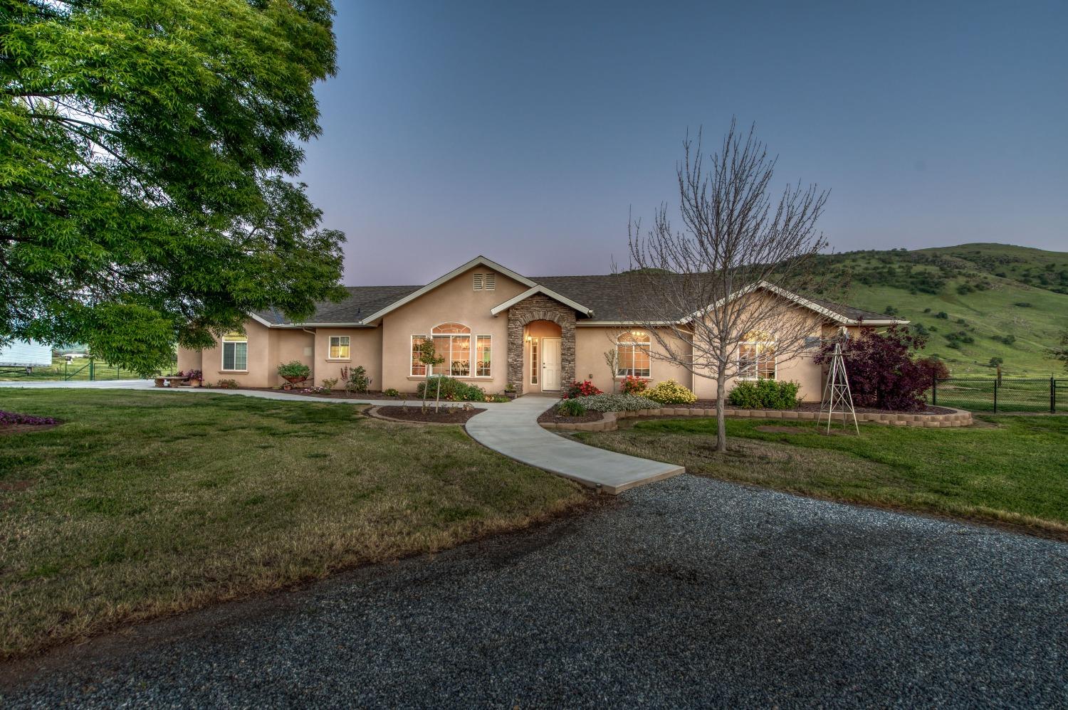 20431 Thermal Road Sanger, CA 93657 - Photo 1 of 88 a front view of a house with a yard and garage
