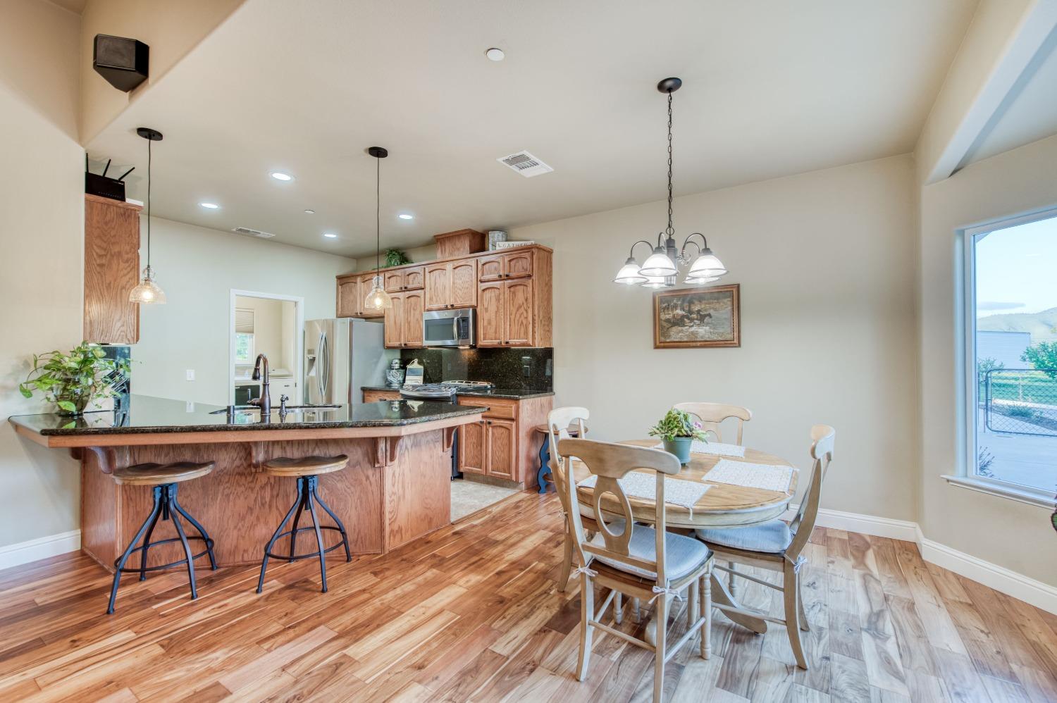 20431 Thermal Road Sanger, CA 93657 - Photo 12 of 88 a dining room filled chandelier and wooden floor