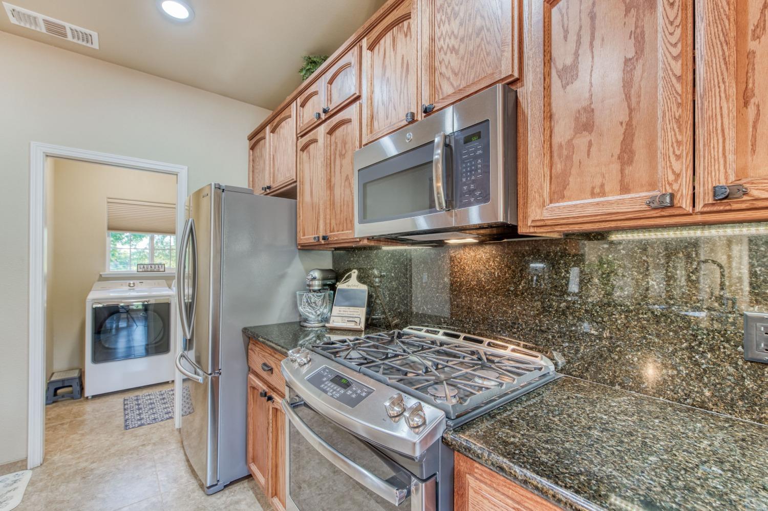 20431 Thermal Road Sanger, CA 93657 - Photo 19 of 88 a stove top oven sitting inside of a kitchen