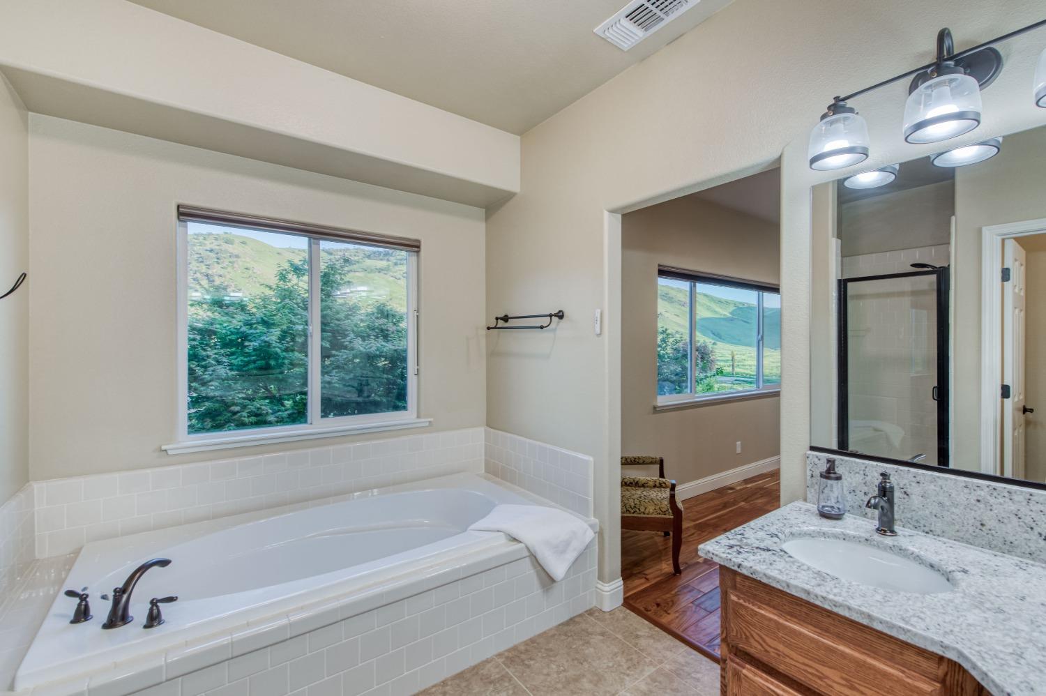 20431 Thermal Road Sanger, CA 93657 - Photo 23 of 88 a bathroom with a granite countertop tub sink and mirror