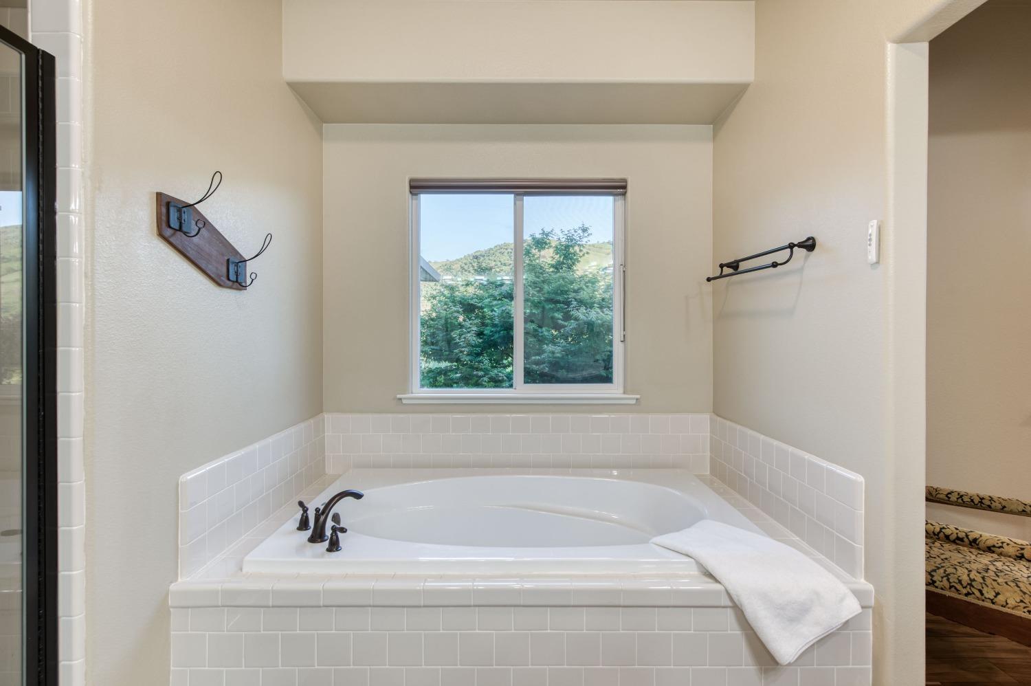 20431 Thermal Road Sanger, CA 93657 - Photo 24 of 88 a white bath tub sitting in a bathroom next to a window