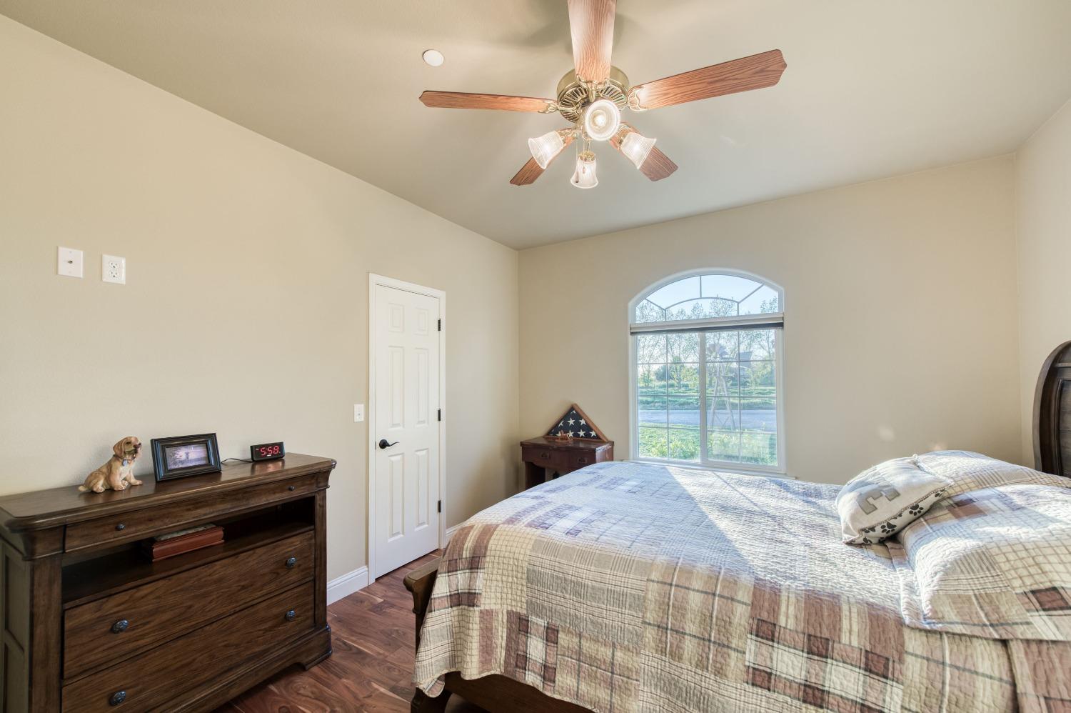 20431 Thermal Road Sanger, CA 93657 - Photo 27 of 88 a bedroom with a bed and a chandelier