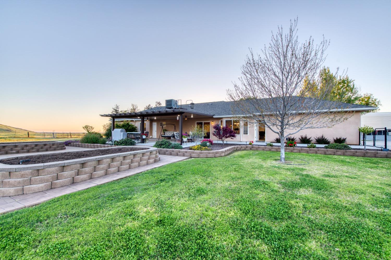 20431 Thermal Road Sanger, CA 93657 - Photo 33 of 88 a view of a house with a big yard potted plants and large tree