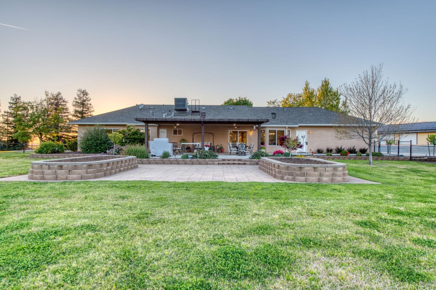 20431 Thermal Road Sanger, CA 93657 - Photo 34 of 88 a front view of a house with a garden and trees