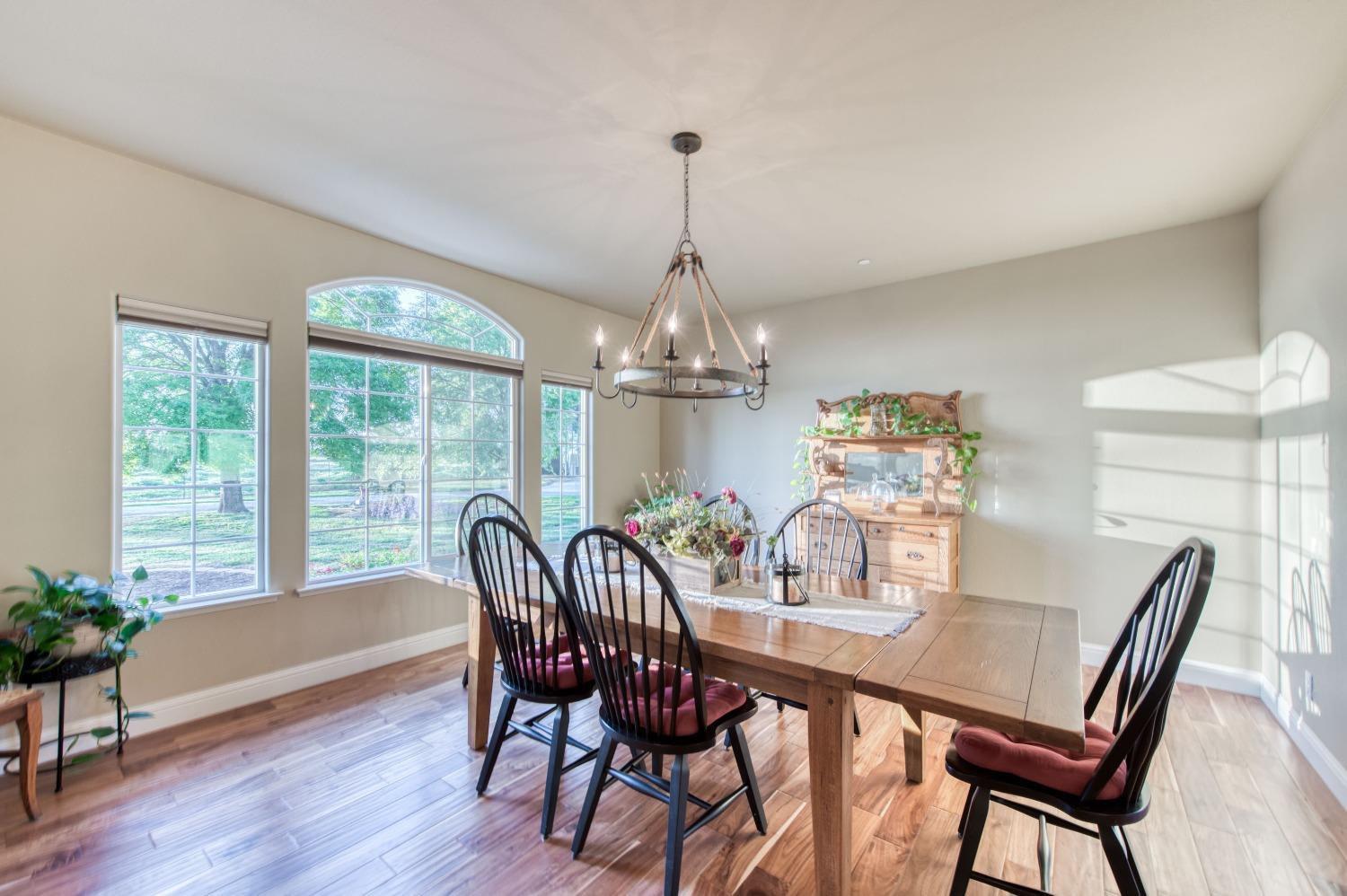 20431 Thermal Road Sanger, CA 93657 - Photo 4 of 88 a dining room with furniture a chandelier and wooden floor