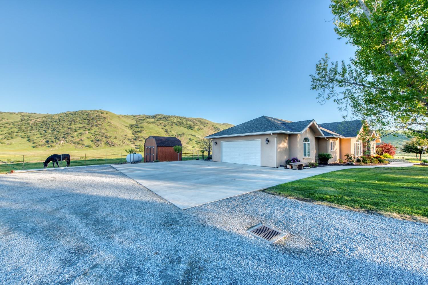20431 Thermal Road Sanger, CA 93657 - Photo 55 of 88 a view of a house with a yard and a large tree